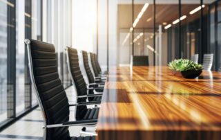 Modern conference room with large windows and wooden table and black leather chairs view